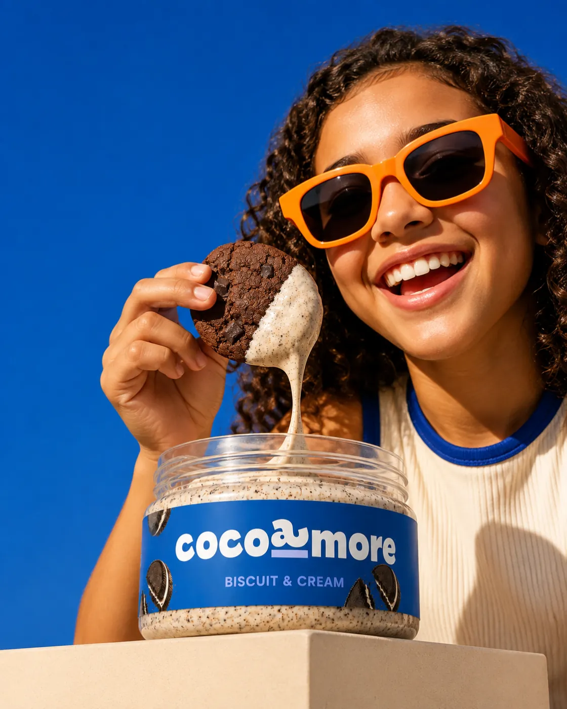 A girl dipping a cookie into Biscuit & Cream