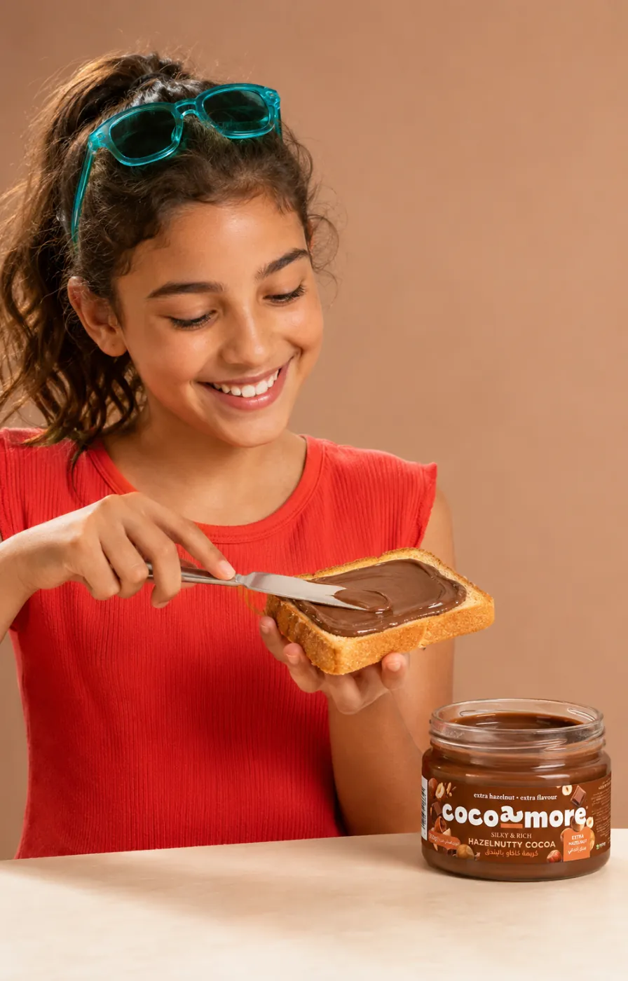 A girl spreading Hazelnutty Cocoa on toast