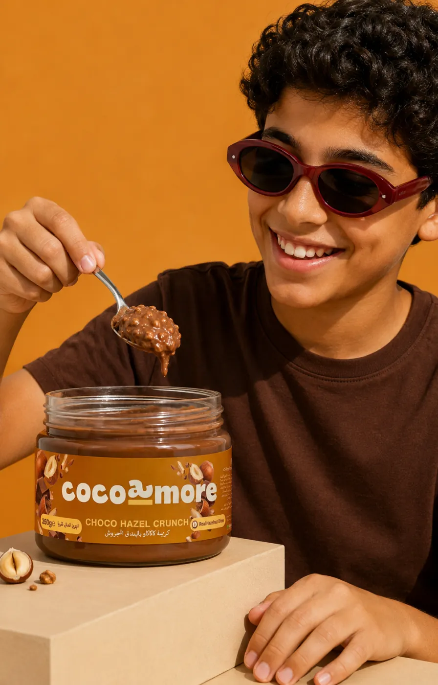 A boy in red sunglasses scooping Choco Hazel Crunch